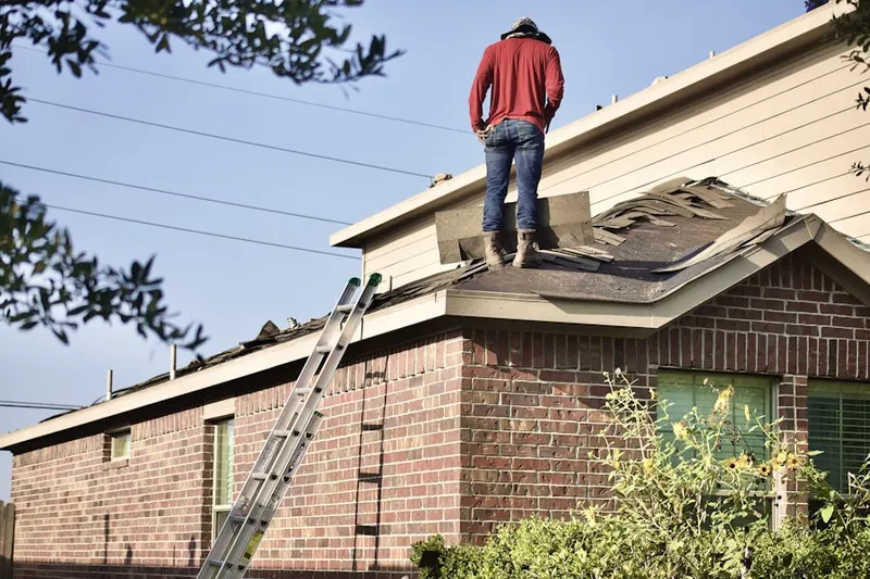 Professional roofer working on a residential roof in East Rancho Dominguez
